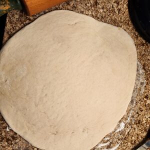 Spreading dough on floured surface